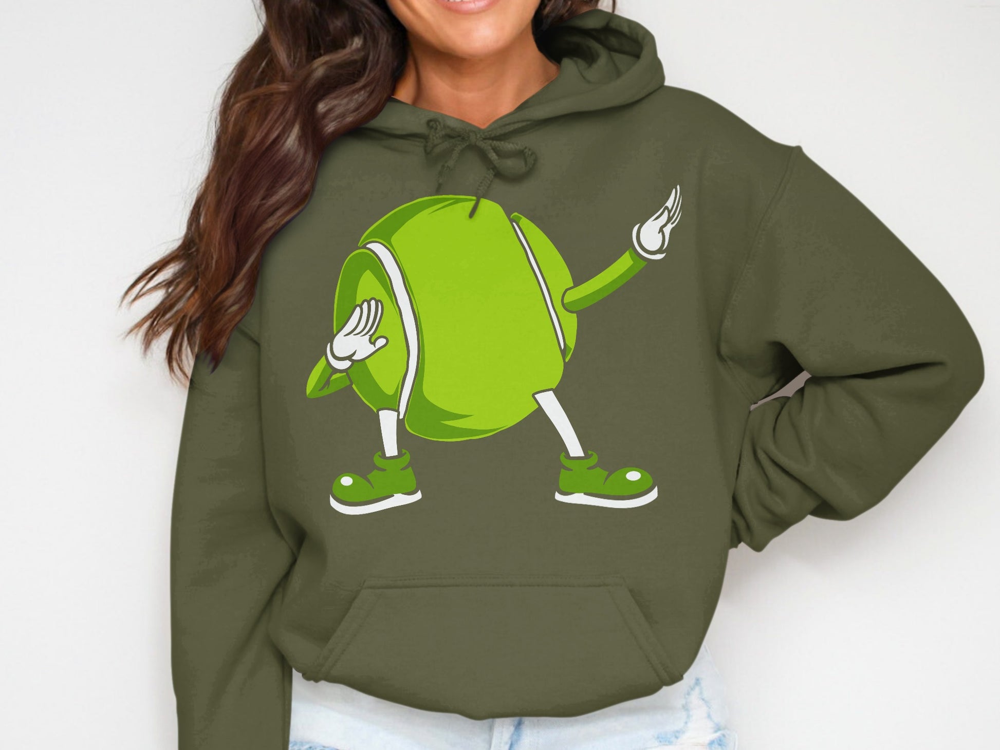 Cartoon tennis ball character dabbing in a green hoodie.
