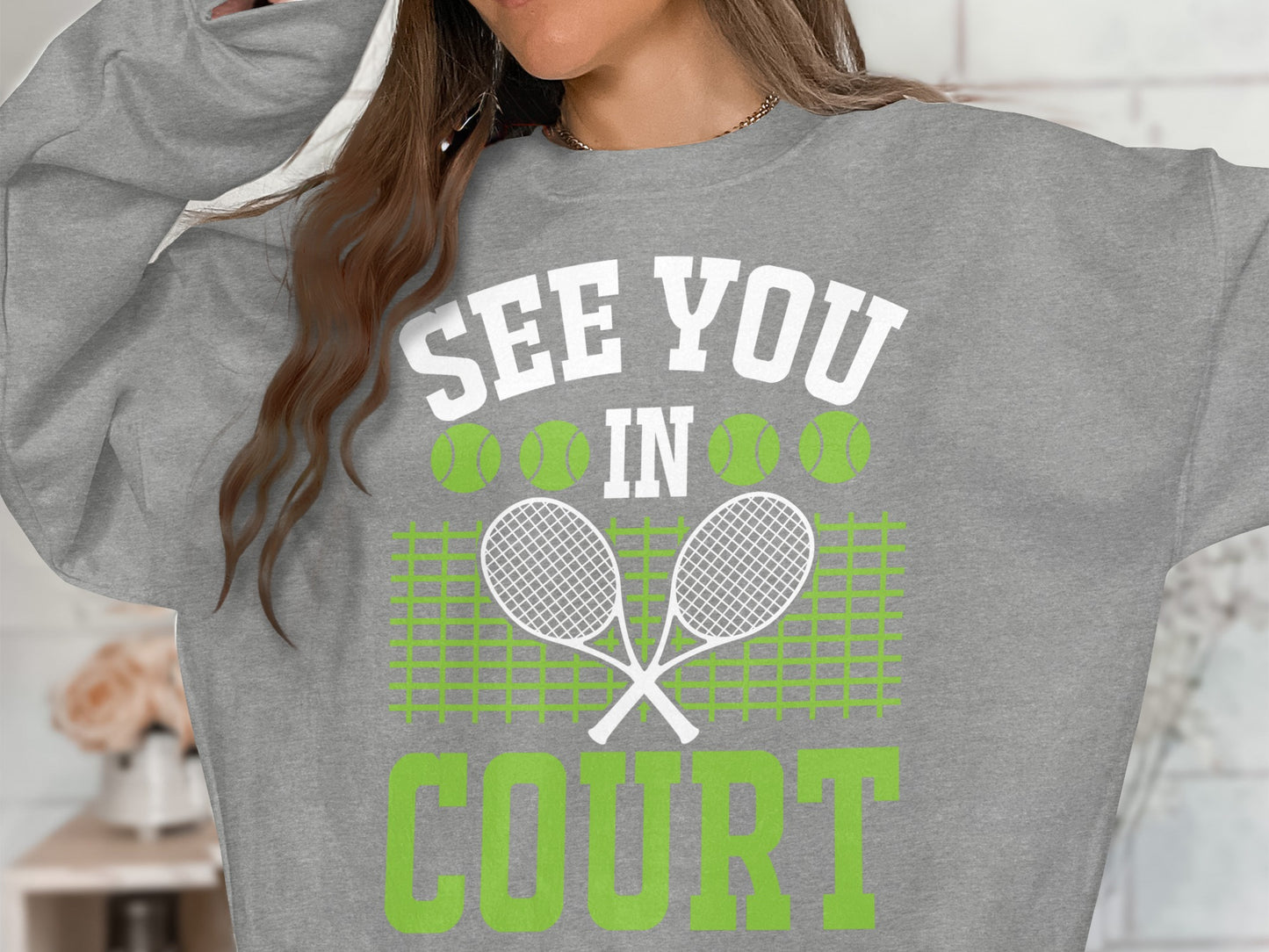 Gray sweatshirt with "SEE YOU IN COURT" and crossed tennis rackets.
