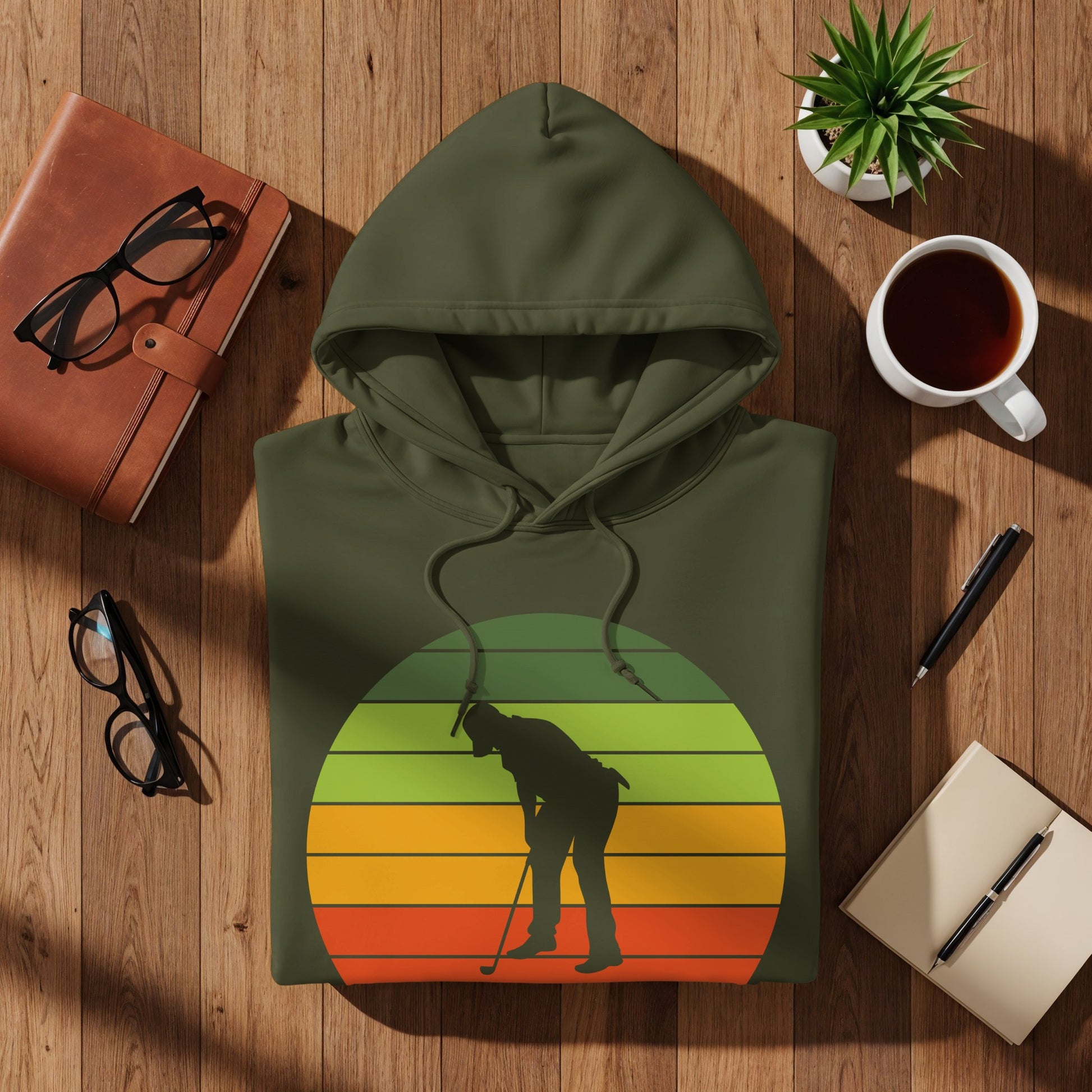 Olive green hoodie with a retro sunset graphic of a golfer.