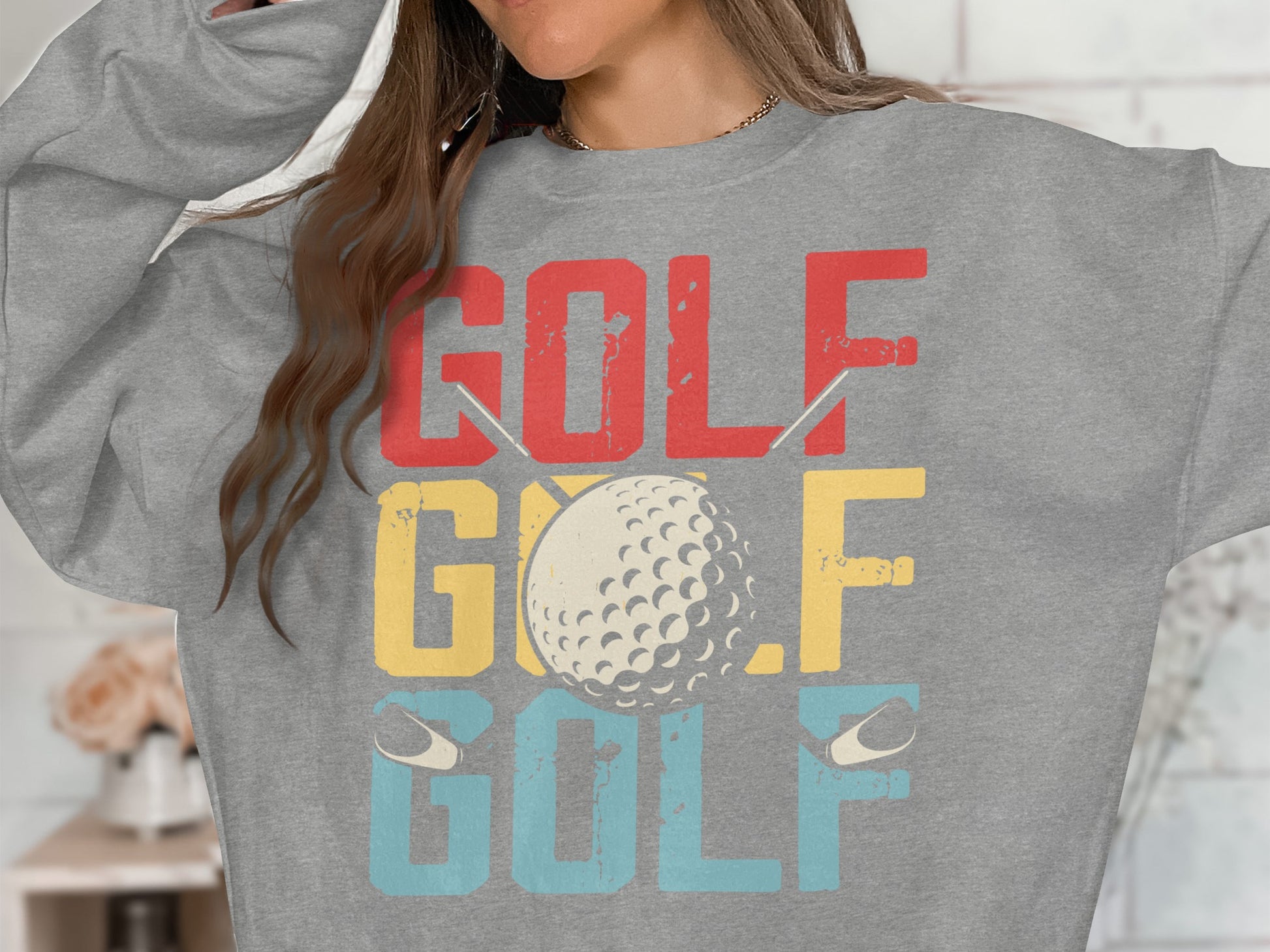 Grey sweatshirt with "GOLF GOLF GOLF" text and a golf ball illustration.