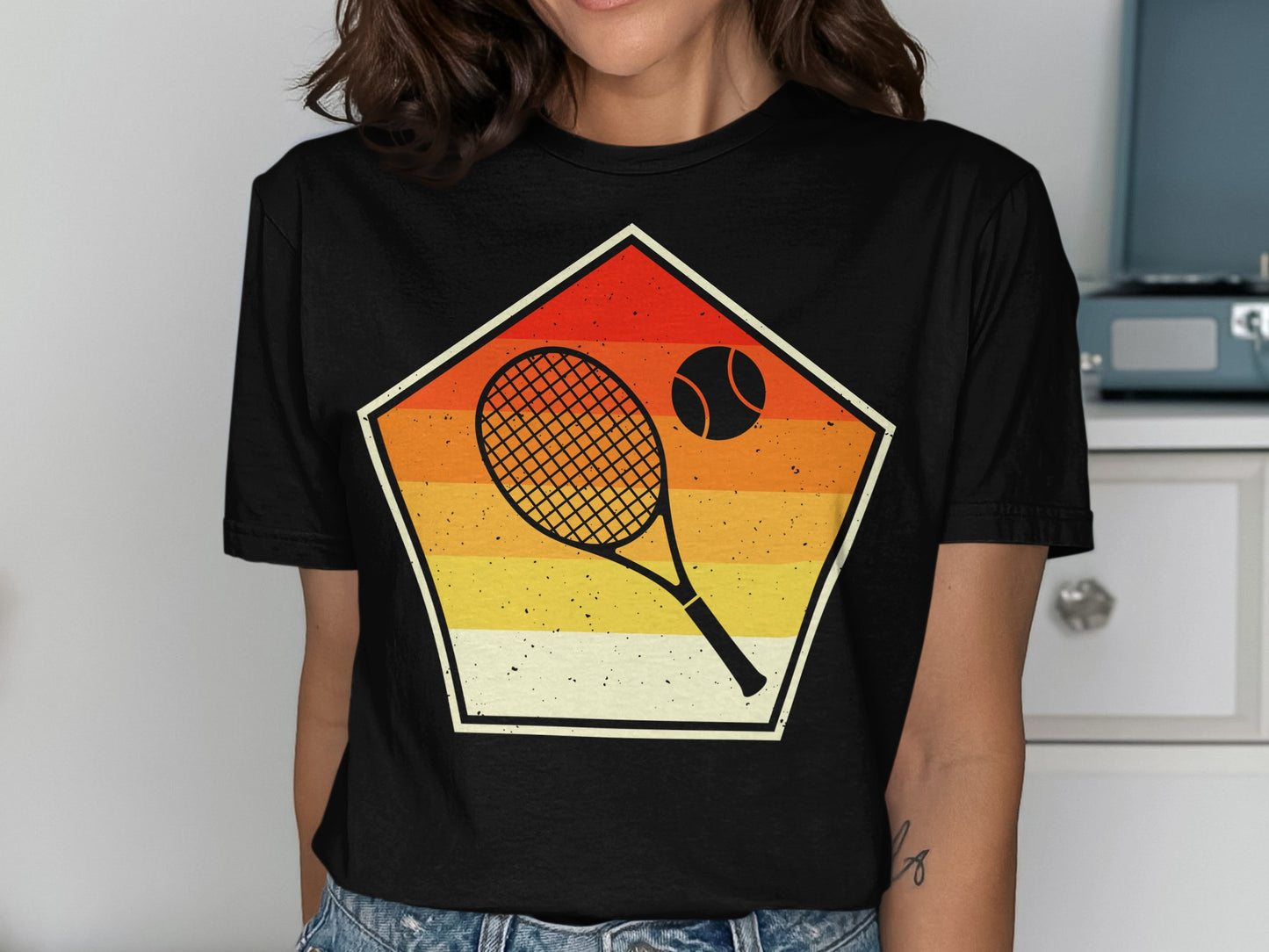 Black t-shirt with a retro pentagon design featuring a tennis racket and ball.