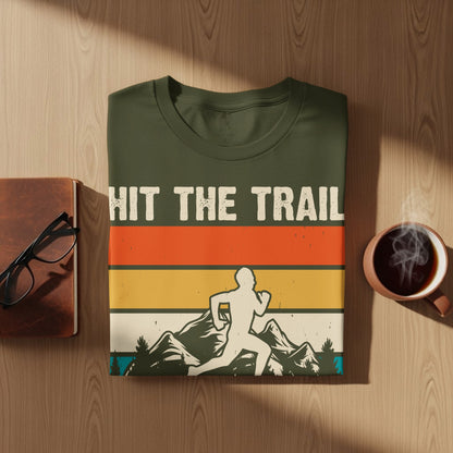Green t-shirt with "HIT THE TRAIL" text and runner silhouette against mountains.