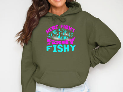 Olive green hoodie with pink and blue "Here Fishy Fishy" text.