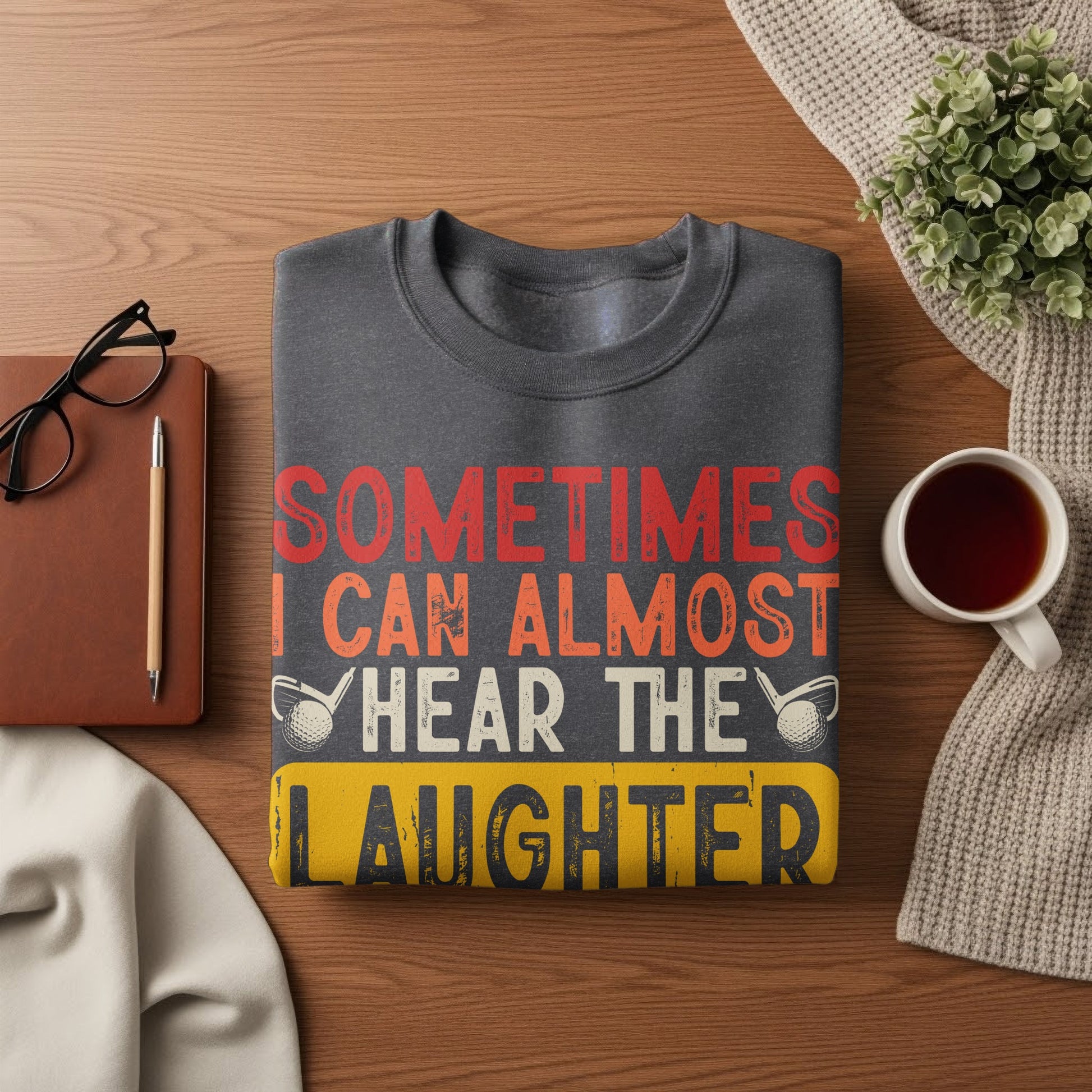 Dark grey sweatshirt with "Sometimes I Can Almost Hear The Laughter" text.