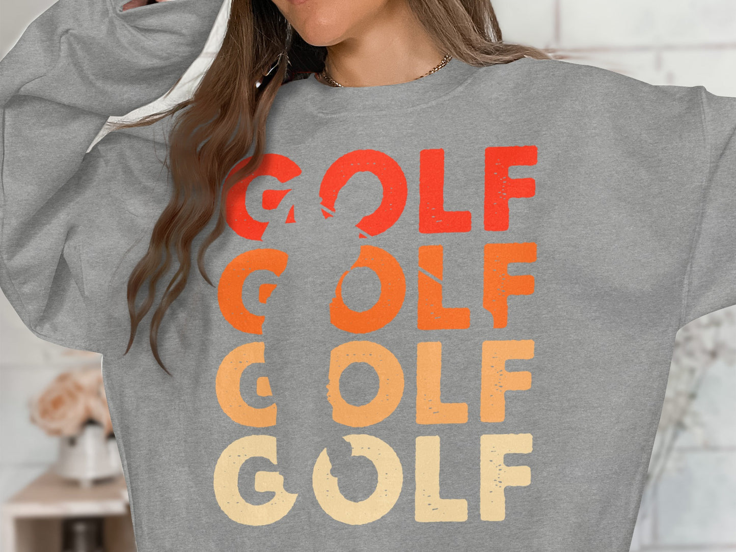 Grey sweatshirt with "GOLF" repeated in orange, red, and yellow text.