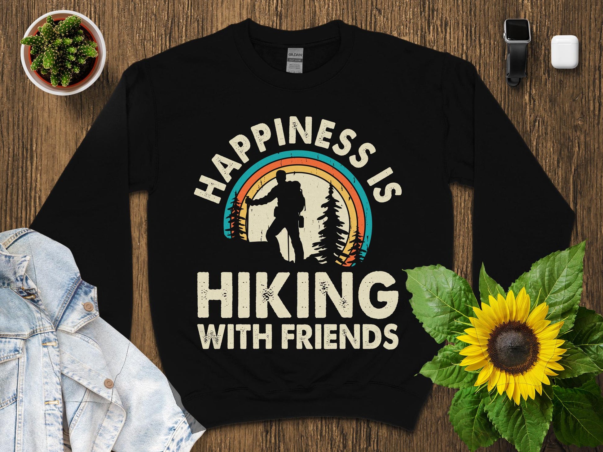 Black sweatshirt with "Happiness is hiking with friends" in retro distressed font.