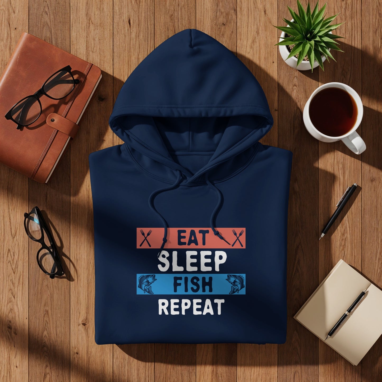 Navy blue hoodie with "Eat Sleep Fish Repeat" text and fish graphics.