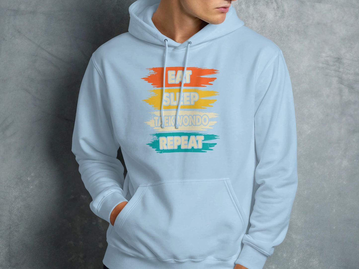 Light blue hoodie with "Eat Sleep Taekwondo Repeat" text.
