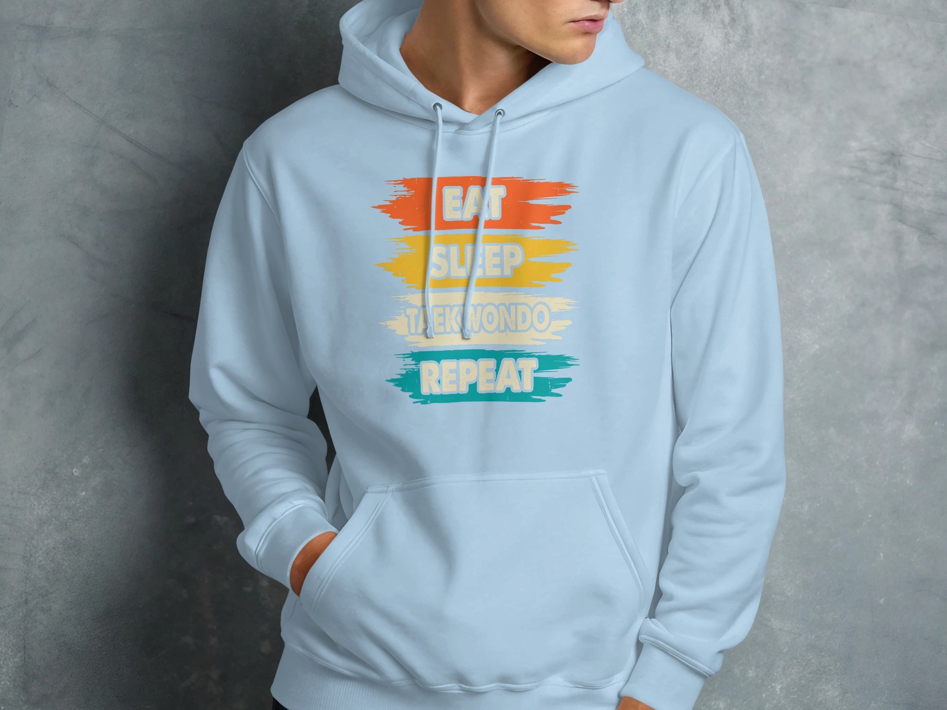 Light blue hoodie with "Eat Sleep Taekwondo Repeat" text.