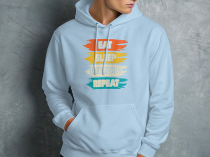 Light blue hoodie with "Eat Sleep Taekwondo Repeat" text.
