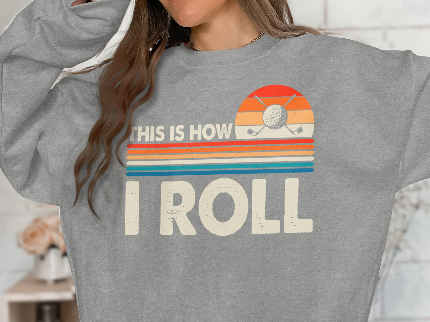 Grey sweatshirt with "This is how I roll" graphic and golf imagery.