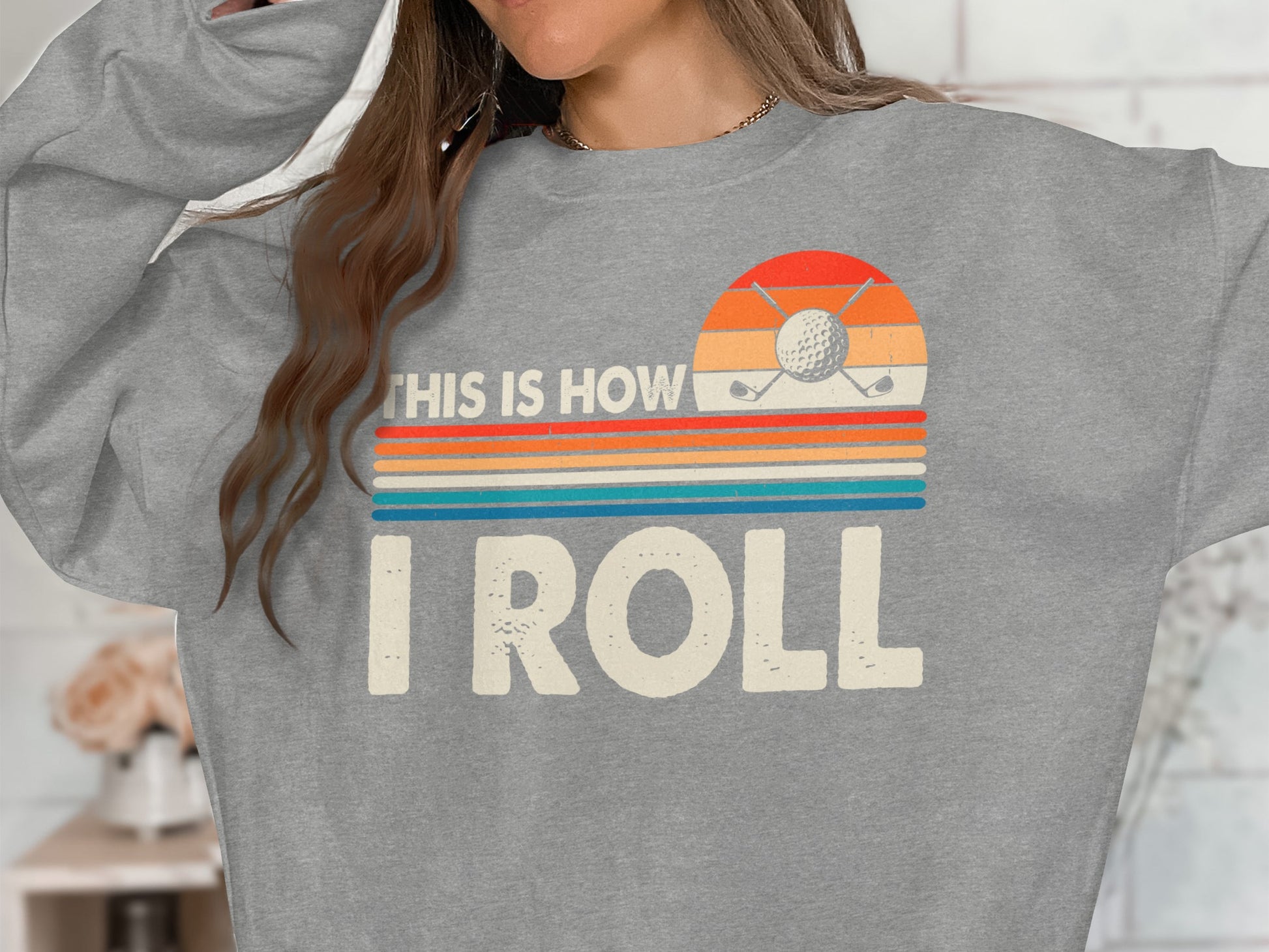 Grey sweatshirt with "This is how I roll" graphic and golf imagery.