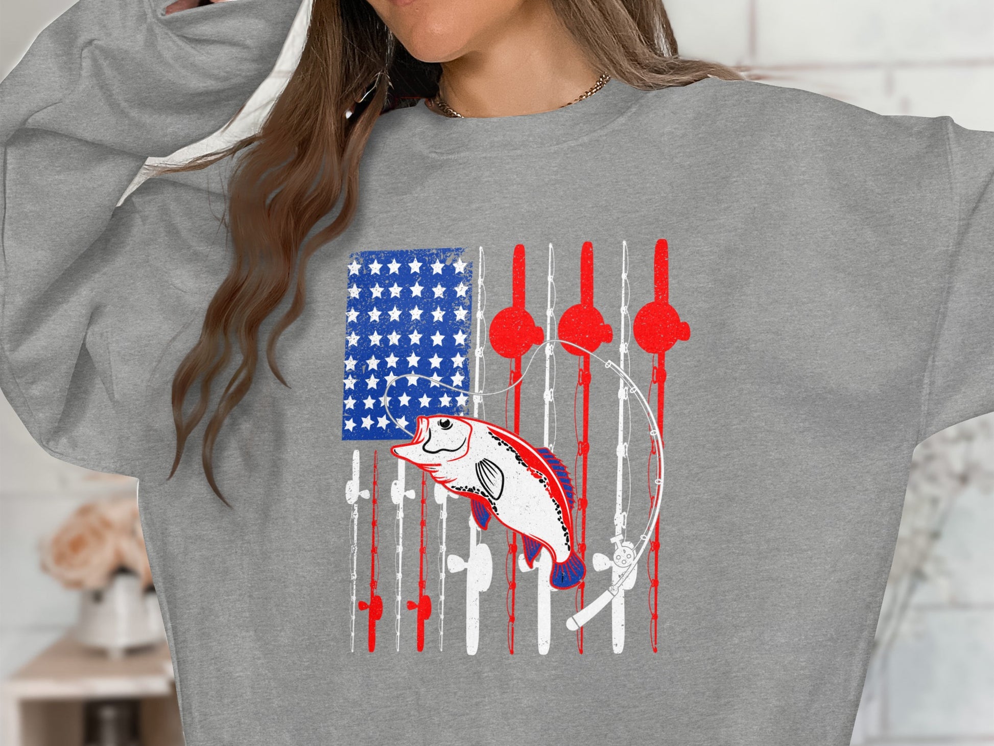 Gray sweatshirt with American flag design featuring fishing rods and a bass fish.
