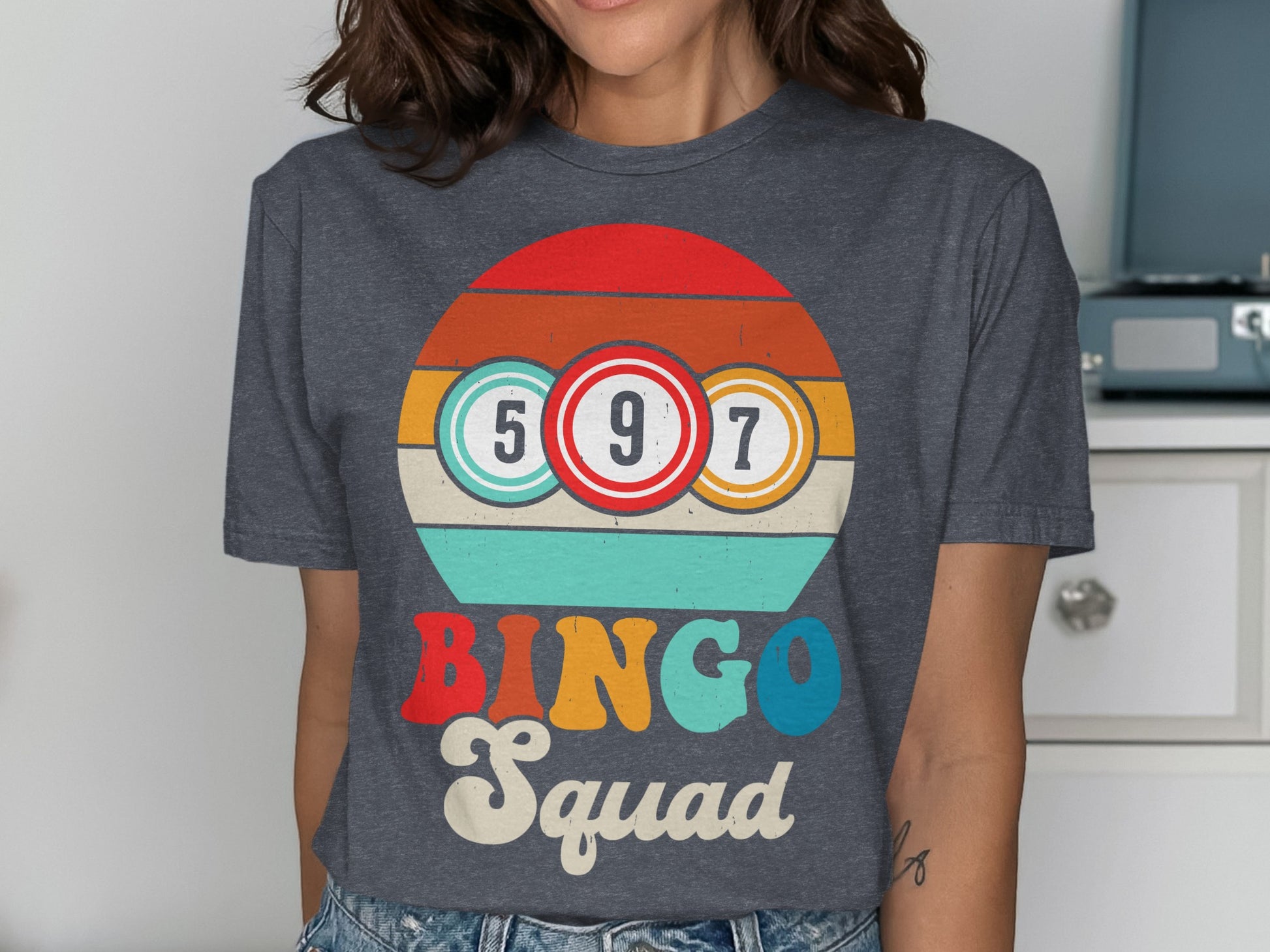 Bingo Squad graphic with numbered balls and colorful stripes on a dark gray t-shirt.