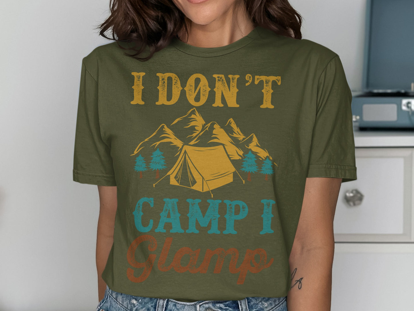 Green t-shirt with "I DON'T CAMP I GLAMP" text and camping graphic.