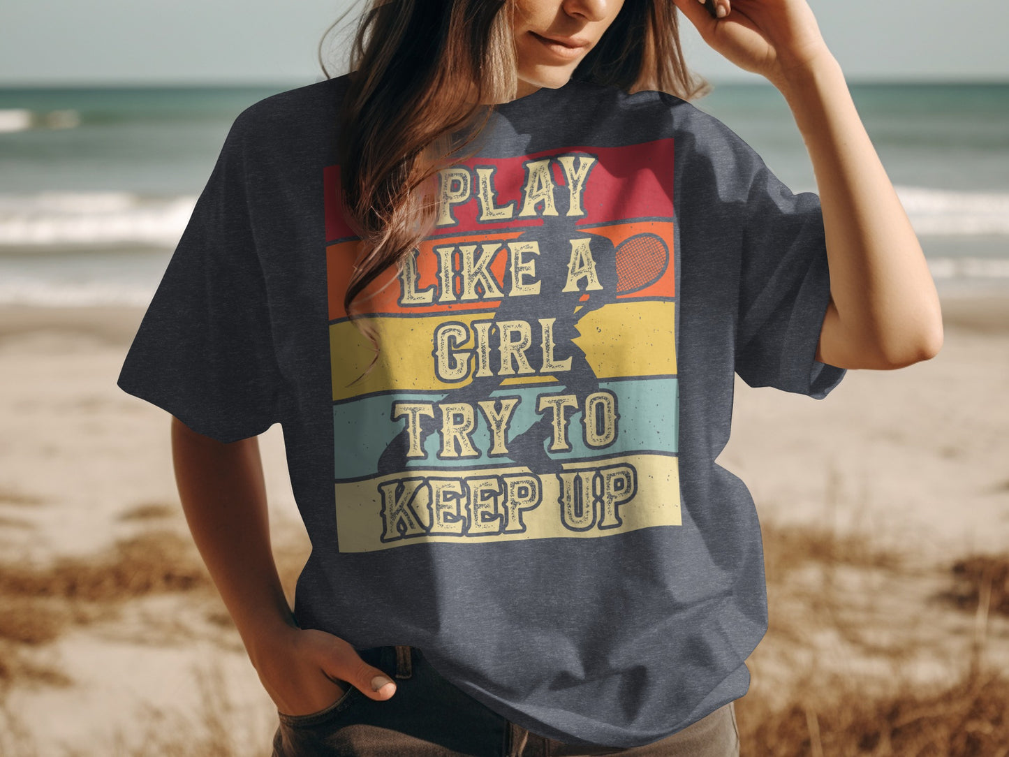 T-shirt graphic with retro colors: "PLAY LIKE A GIRL TRY TO KEEP UP".
