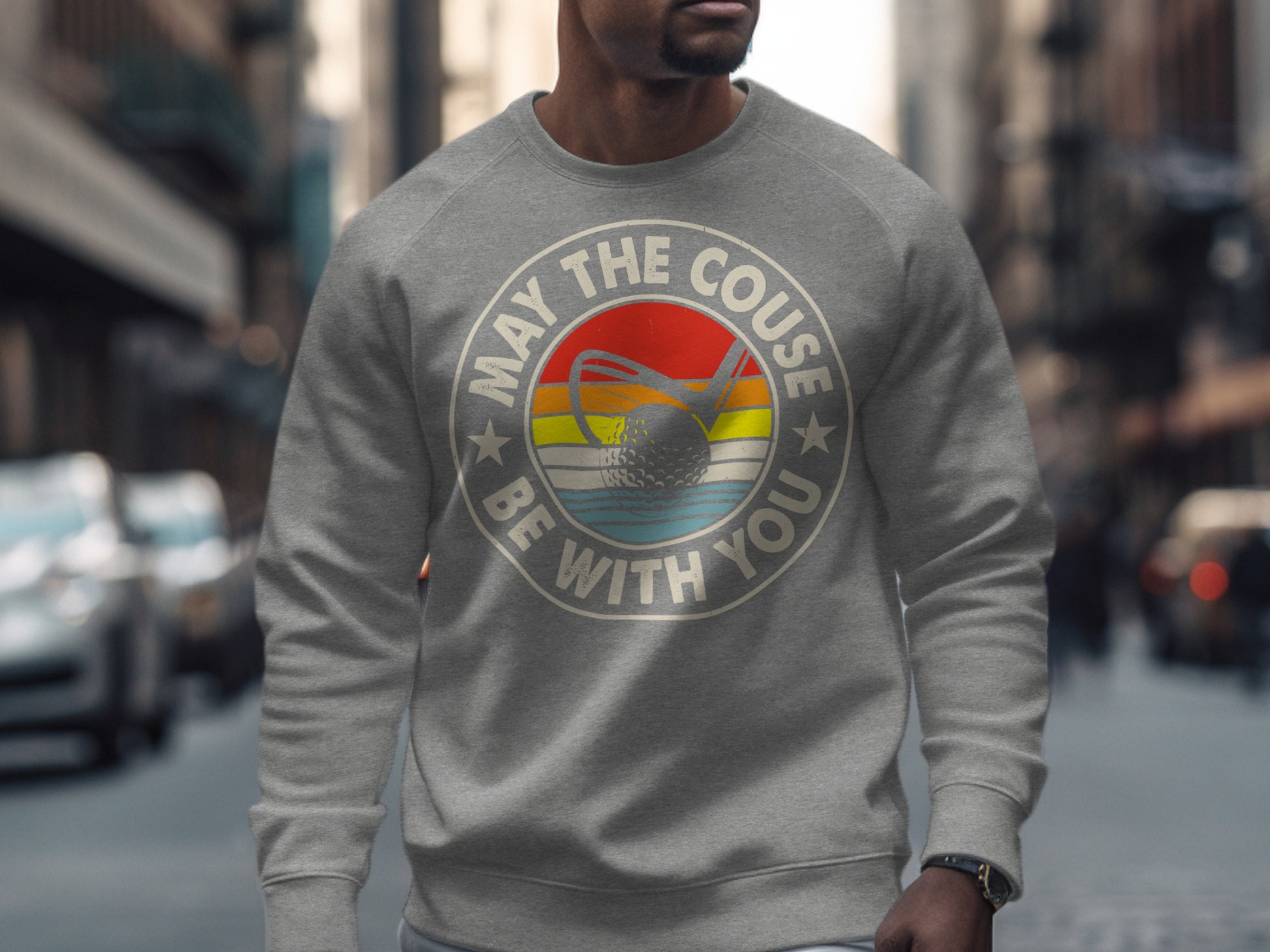 Gray sweatshirt with "May the Course be with you" and a golf ball.