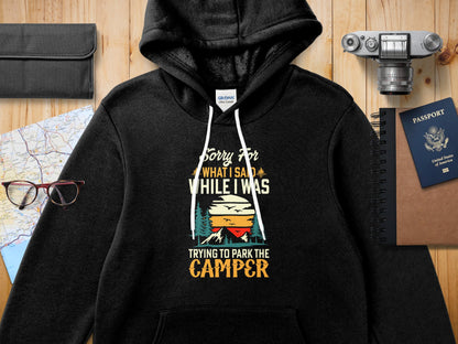 Black hoodie with "Sorry For What I Said While I Was Trying To Park The Camper" graphic.