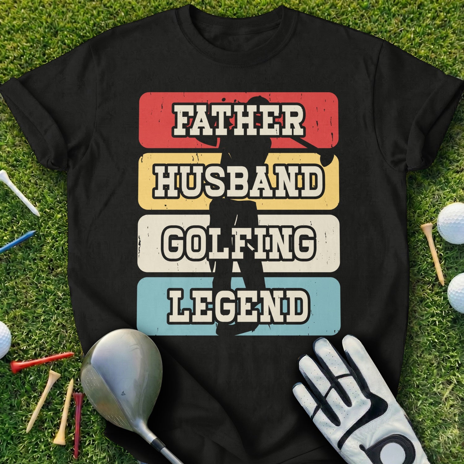 Black t-shirt with "FATHER HUSBAND GOLFING LEGEND" in distressed colorful text.