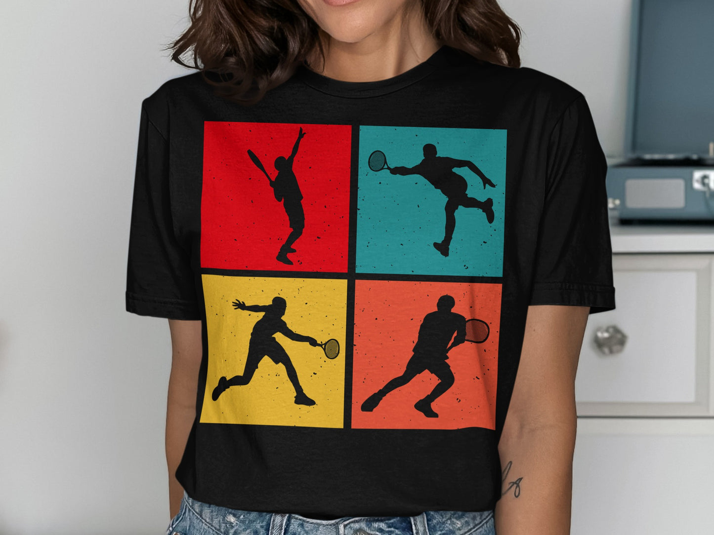 Black t-shirt featuring four colorful square panels with tennis player silhouettes.