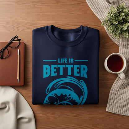 Navy sweatshirt with "Life is Better" text and a stylized fish graphic.