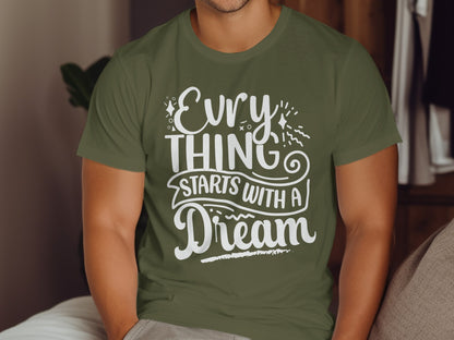 Olive green t-shirt with white text "Everything Starts With A Dream".