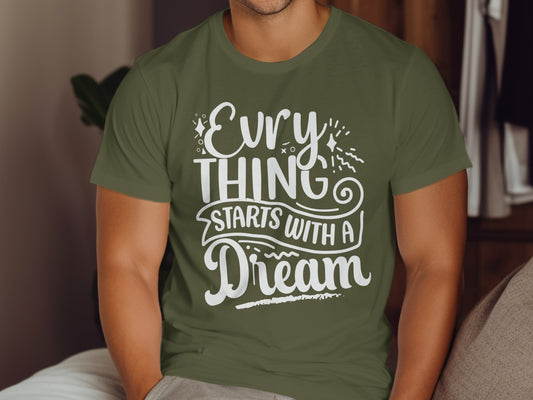 Olive green t-shirt with white text "Everything Starts With A Dream".