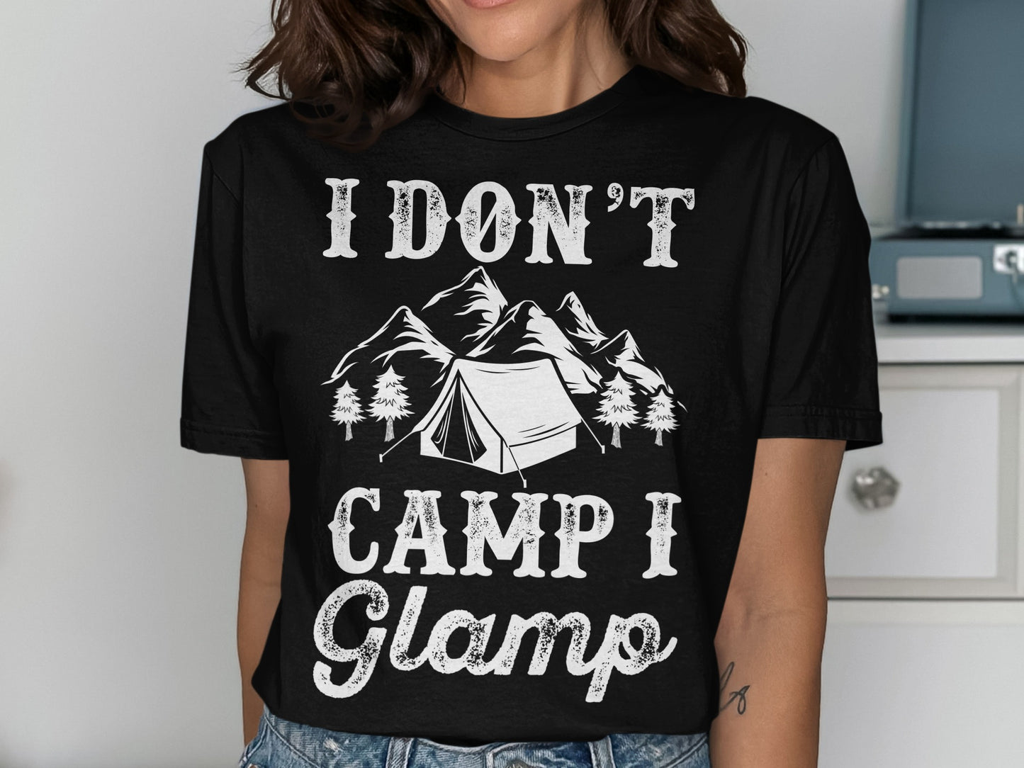 Black t-shirt with "I DON'T CAMP I Glamp" text and mountain and tent graphic.