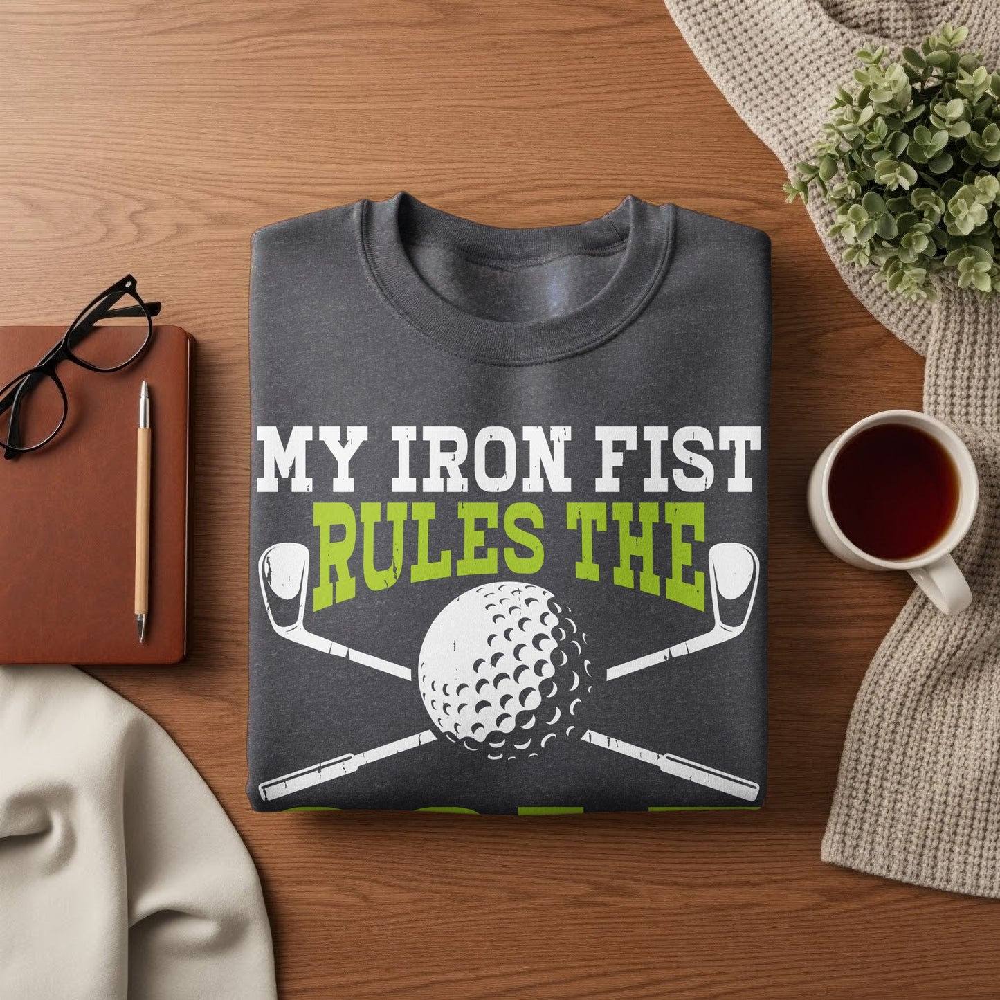 Dark sweatshirt with "My Iron Fist Rules The" text and golf club and ball graphic.