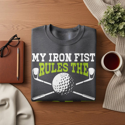 Dark sweatshirt with "My Iron Fist Rules The" text and golf club and ball graphic.