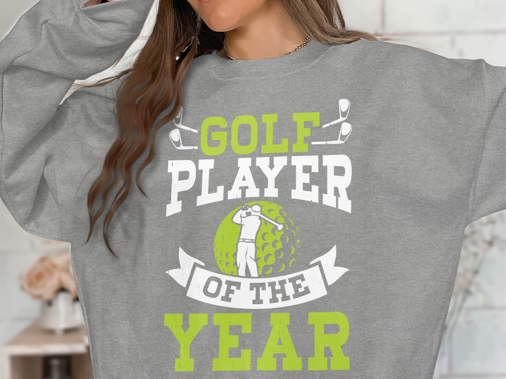 Gray sweatshirt with "GOLF PLAYER OF THE YEAR" text and golfer graphic.