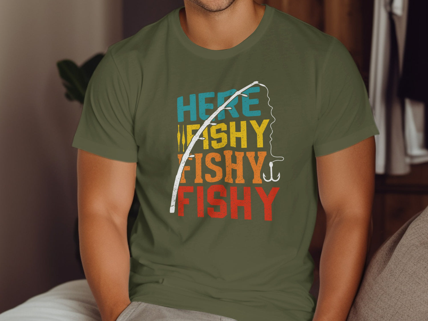 Olive green t-shirt with "HERE WE GO FISHY FISHY FISHY" text and fishing hook.