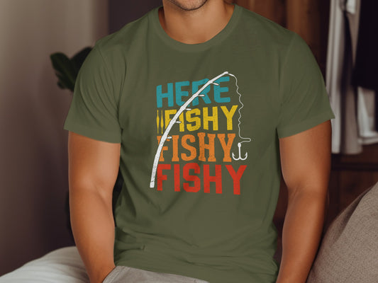 Olive green t-shirt with "HERE WE GO FISHY FISHY FISHY" text and fishing hook.