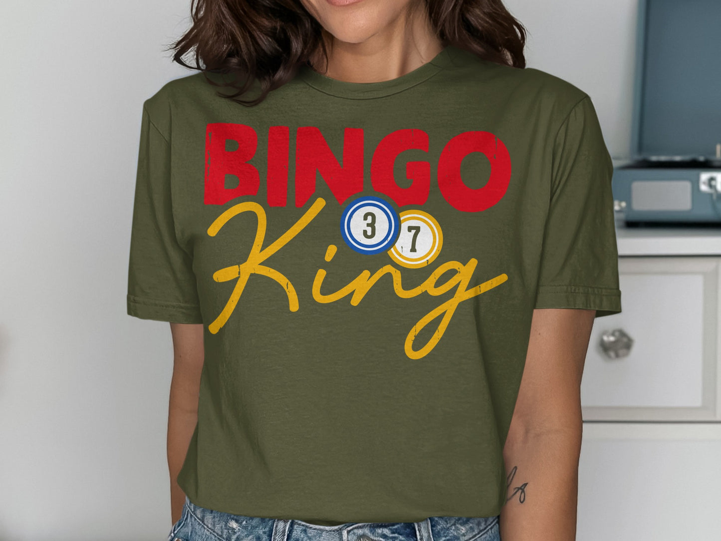 Green t-shirt with red "BINGO" and yellow "King" text, featuring bingo balls.