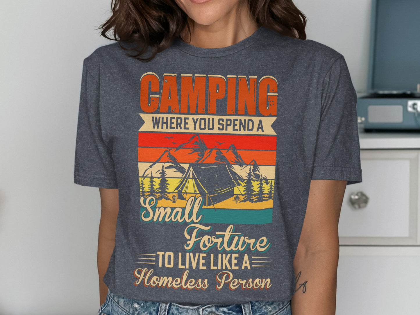 Camping t-shirt with tent, mountains, and text "Camping where you spend a small torture to live like a homeless person."