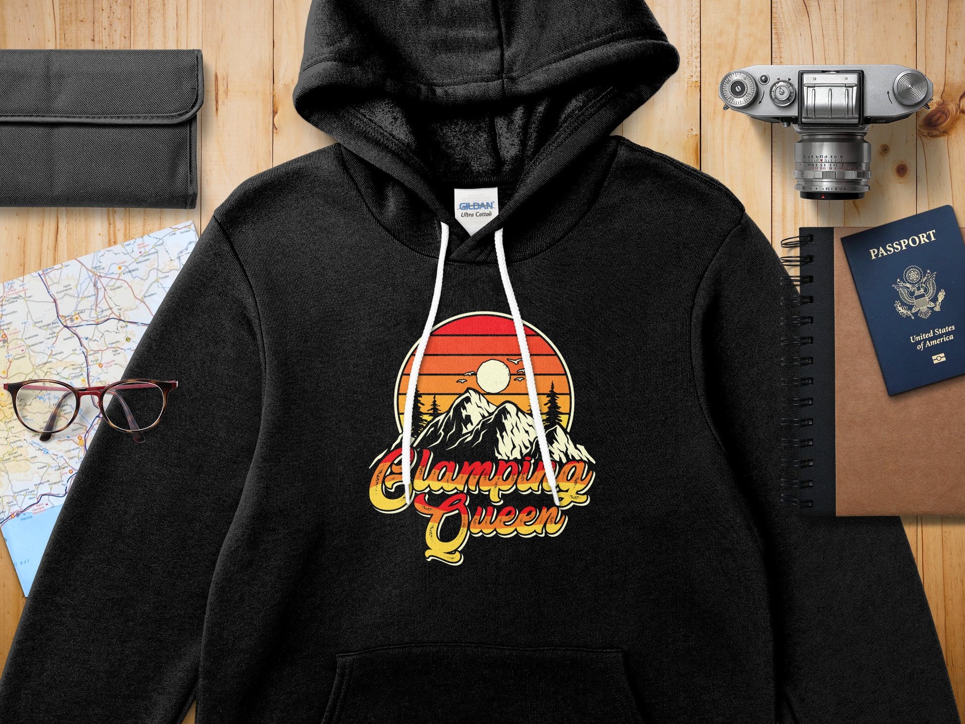 Black hoodie with "Camping Queen" graphic featuring mountains and a sunset.