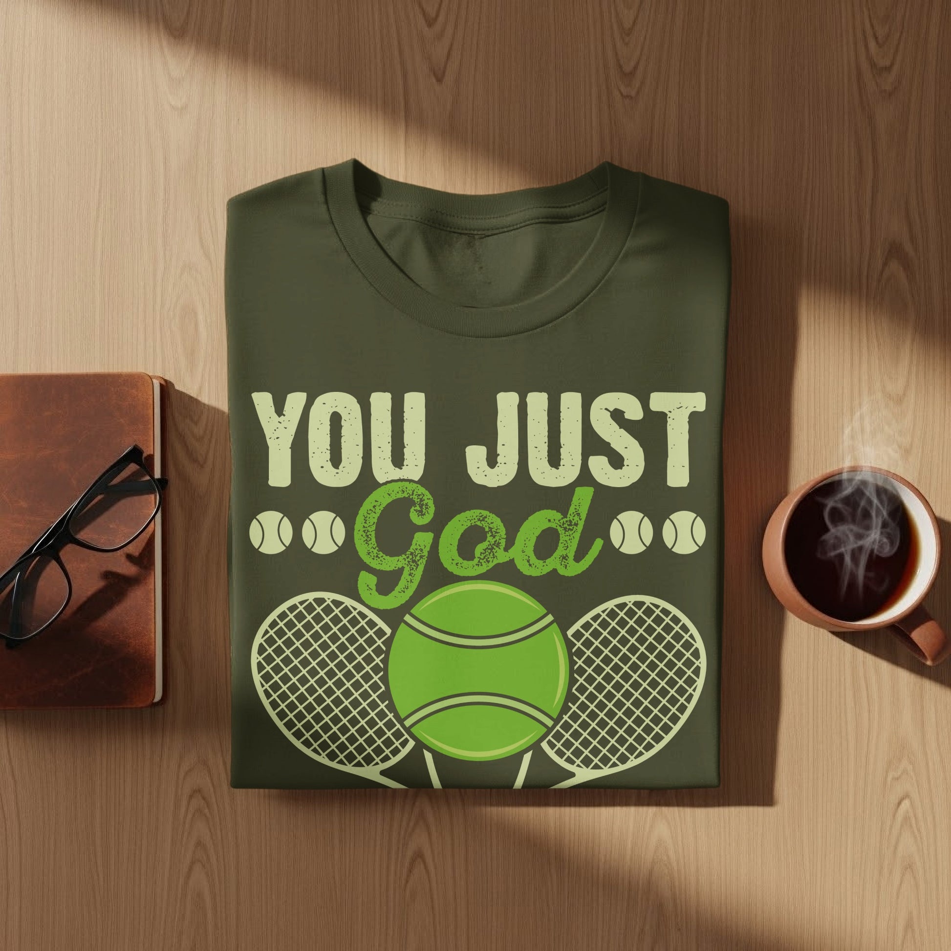 Green t-shirt with "You Just God" text and tennis ball graphic.