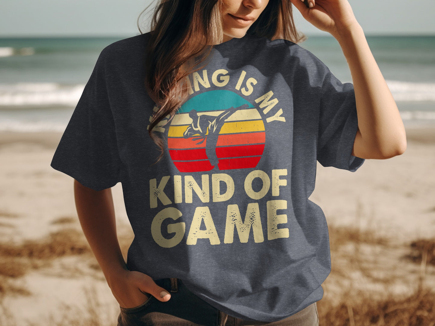 Dark t-shirt with vintage sunset graphic and "KIND OF GAME" text.
