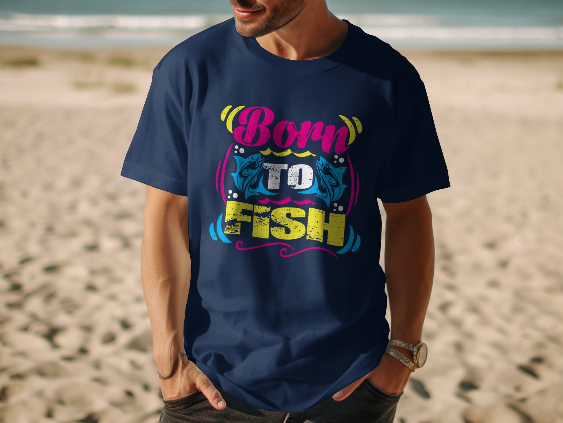 Navy t-shirt with "Born to Fish" text and fish graphic on beach.