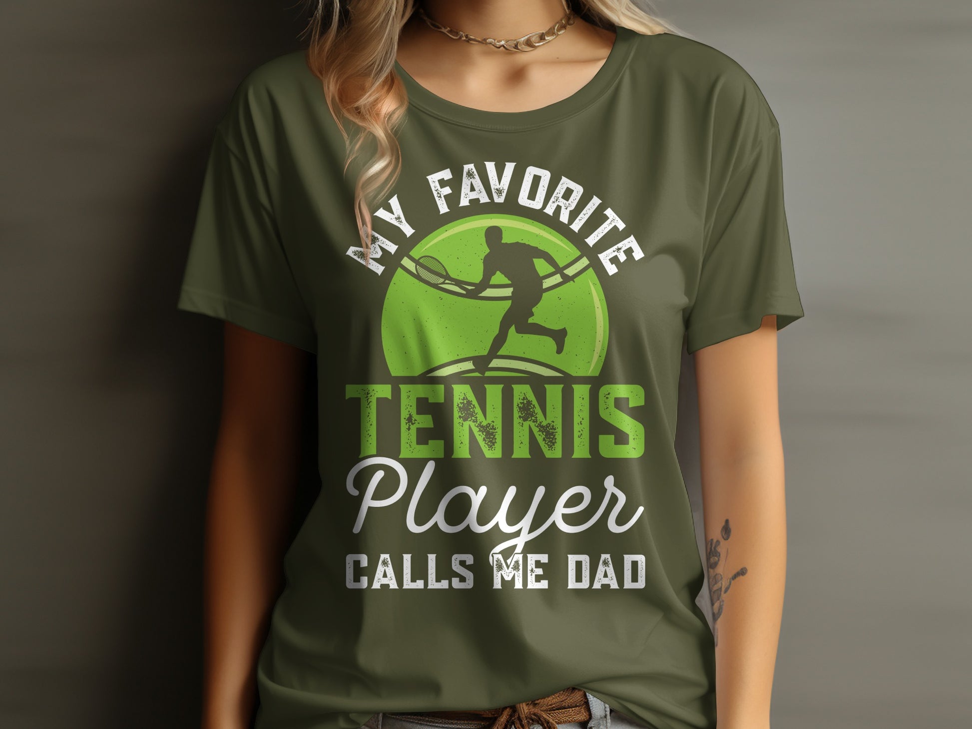 Green t-shirt with "MY FAVORITE TENNIS PLAYER CALLS ME DAD" and tennis graphic.