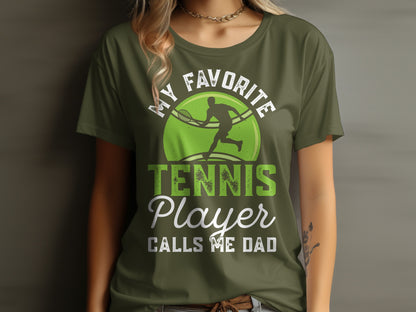 Green t-shirt with "MY FAVORITE TENNIS PLAYER CALLS ME DAD" and tennis graphic.