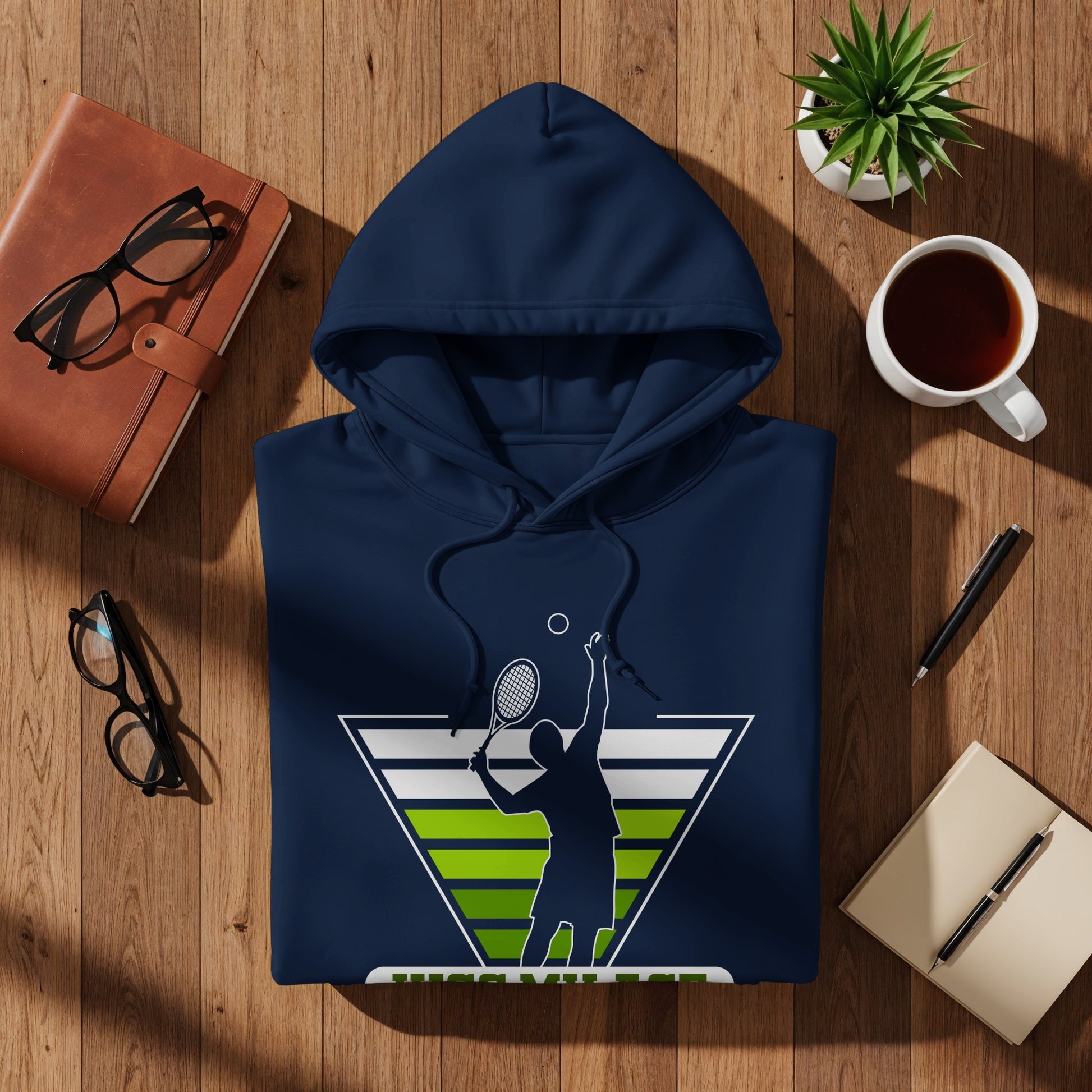 Navy blue hoodie with a tennis player graphic on wooden background.