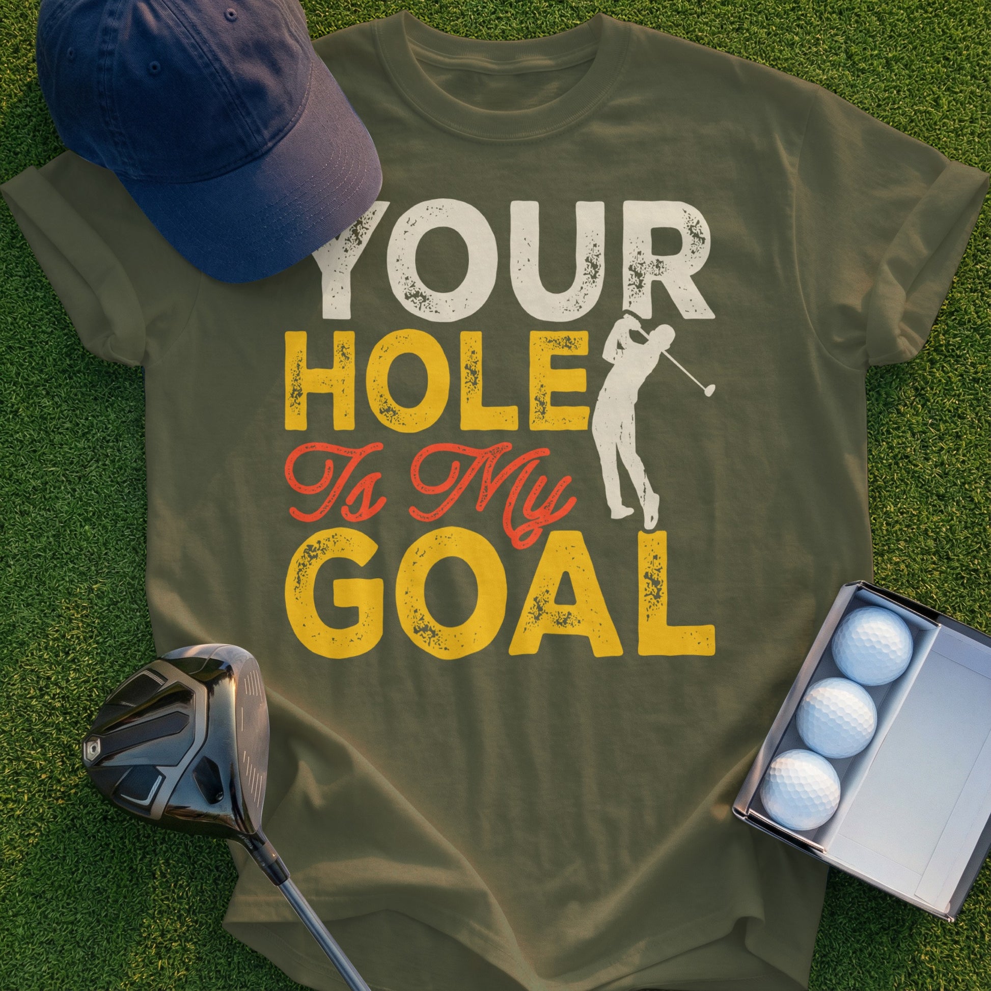 Green t-shirt with "Your Hole Is My Goal" text and golf graphic.