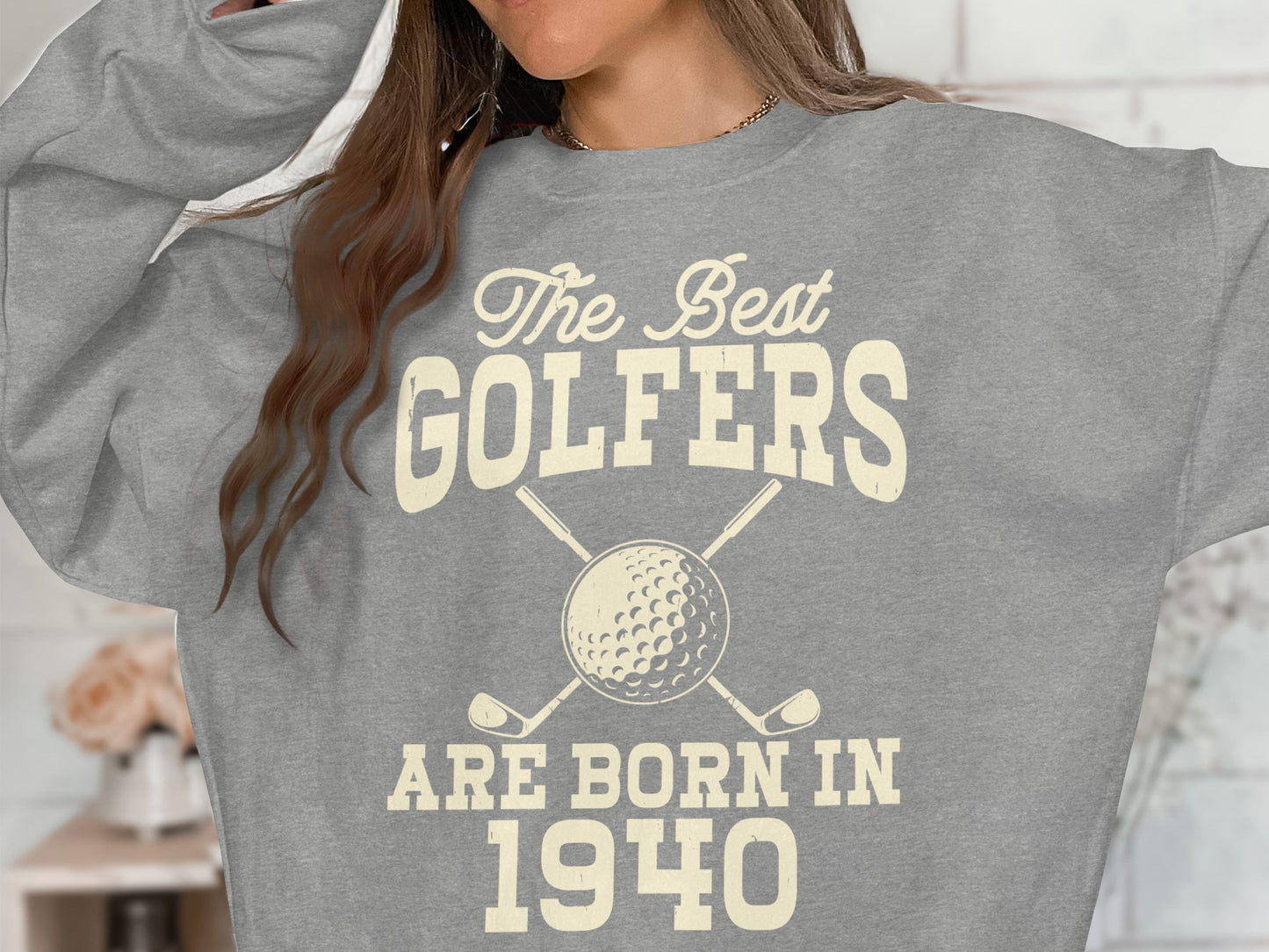 Grey sweatshirt with "The Best Golfers Are Born In 1940" and golf clubs.
