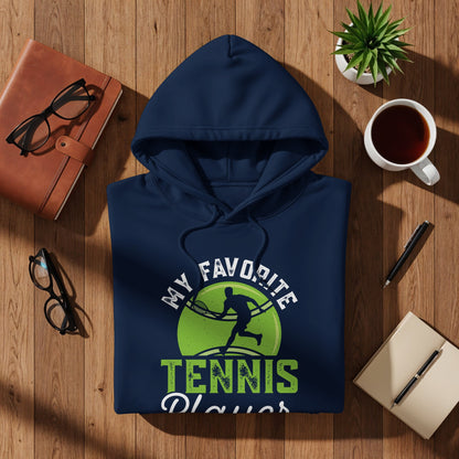 Navy hoodie with "My Favorite Tennis Player" graphic on wooden surface.
