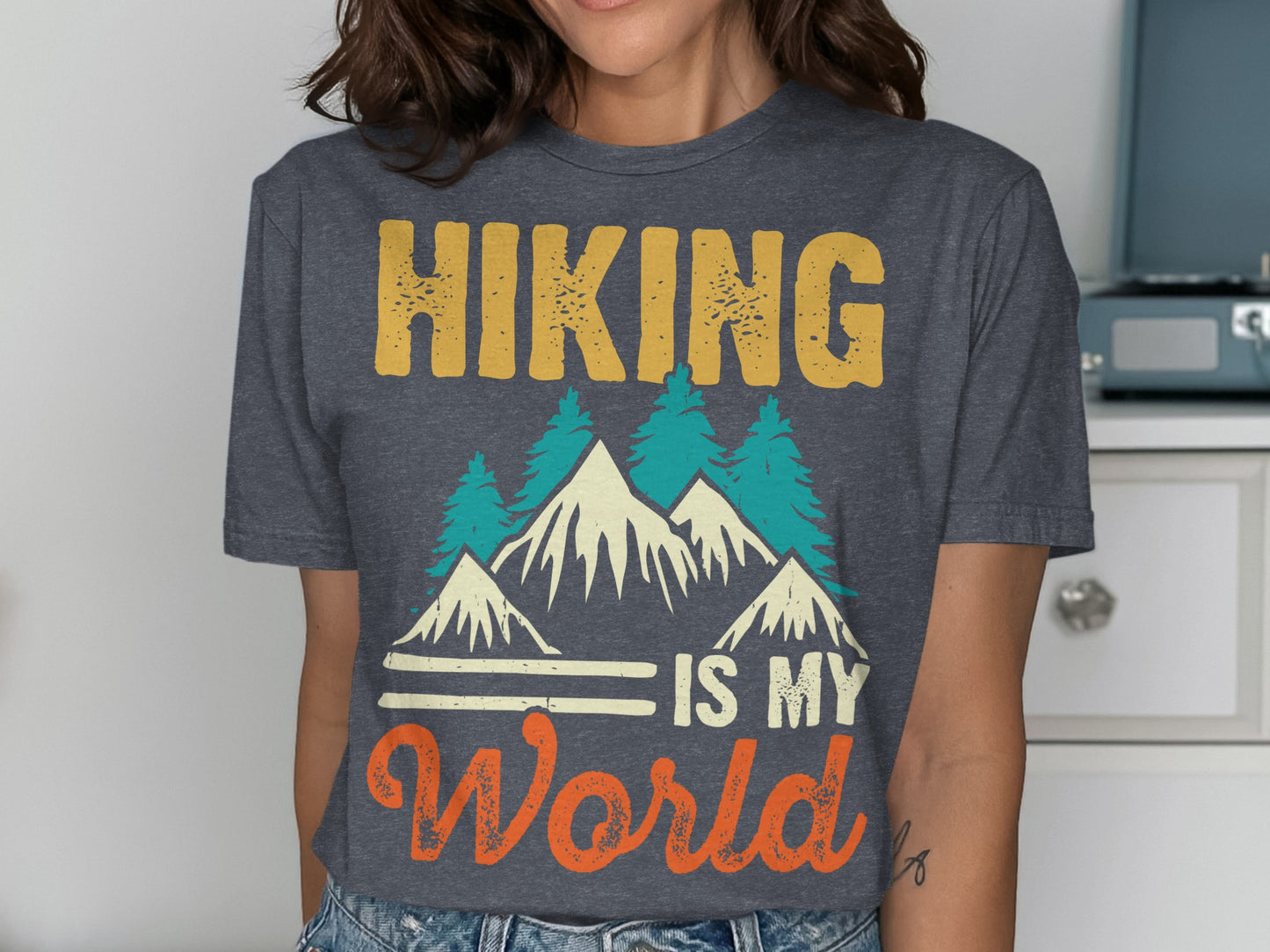Dark grey t-shirt with "Hiking is my world" and mountain graphic.