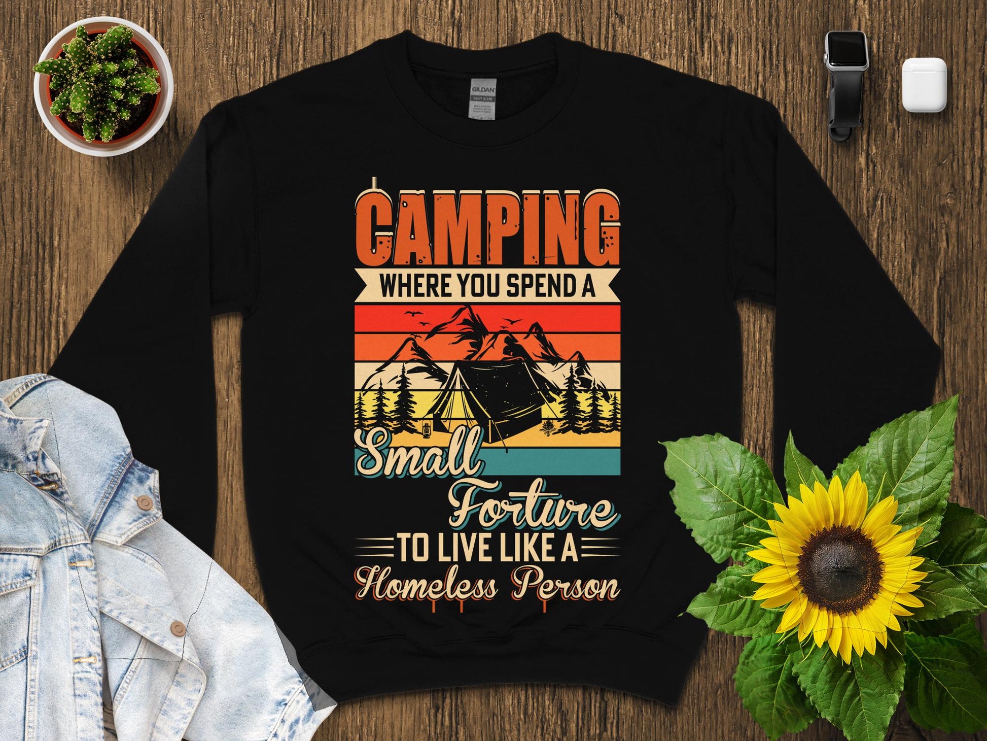 Black sweatshirt with "Camping Where You Spend a Small Fortune to Live Like a Homeless Person" text.
