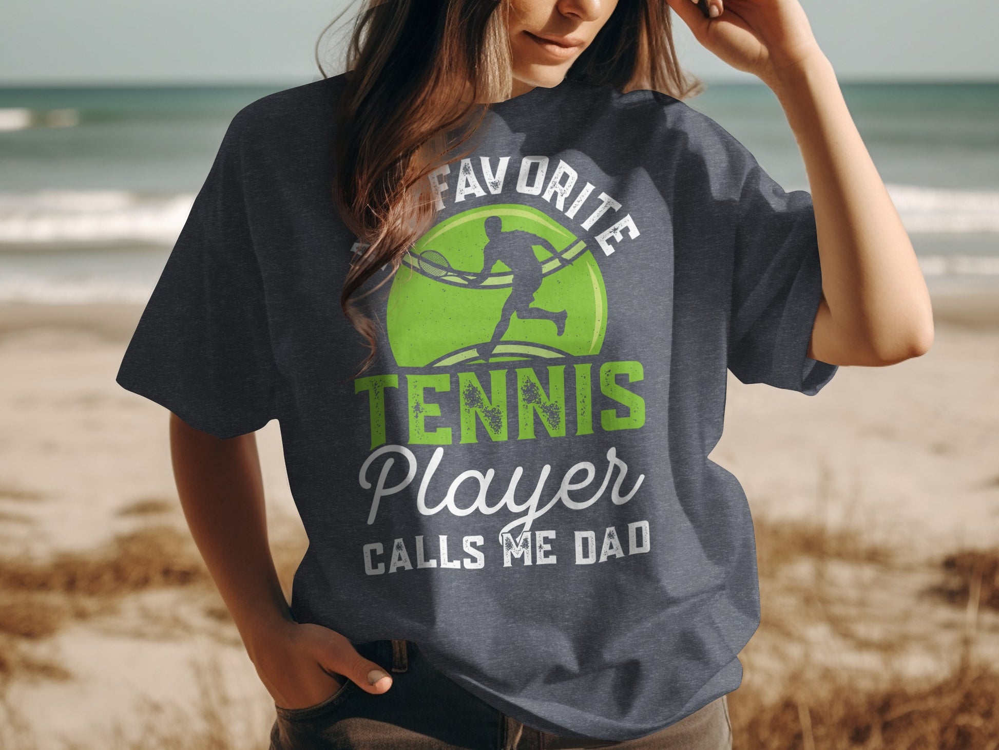 T-shirt with "Favorite Tennis Player Calls Me Dad" text and tennis graphic.
