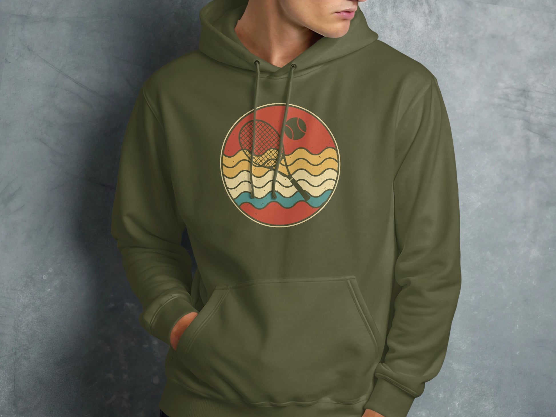 Green hoodie with circular tennis graphic featuring racket, ball, and waves.