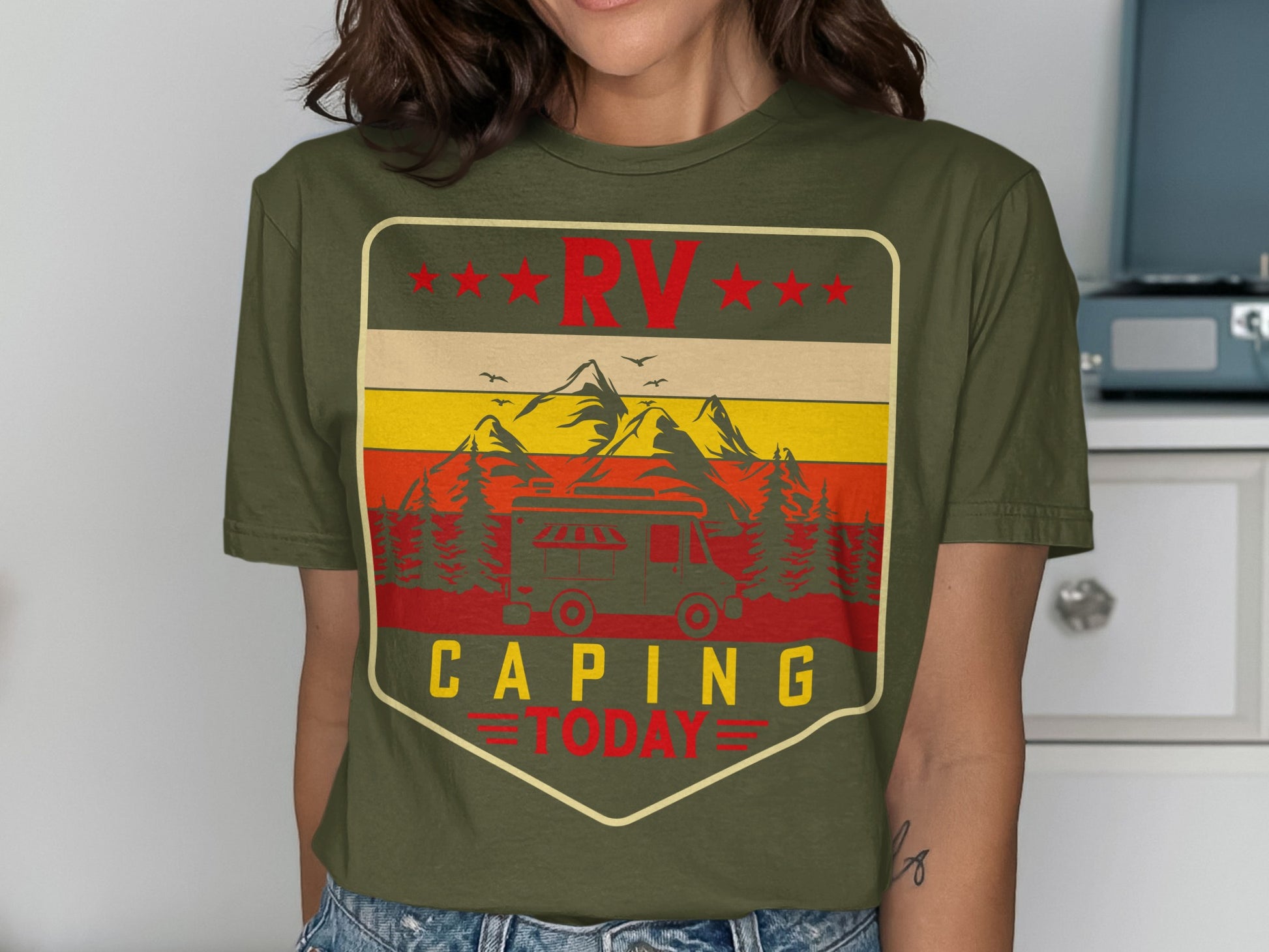 RV Camping Today design on olive green t-shirt with mountains and trees.